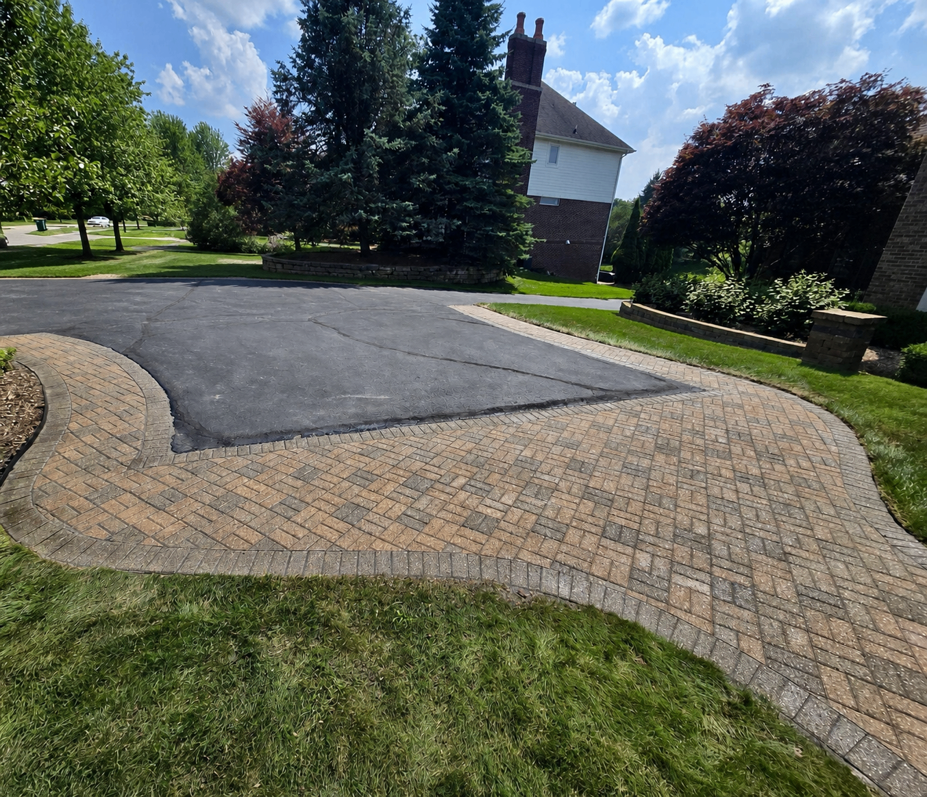 Paver driveway extension widening a Metro Detroit home's driveway with matching interlocking pavers